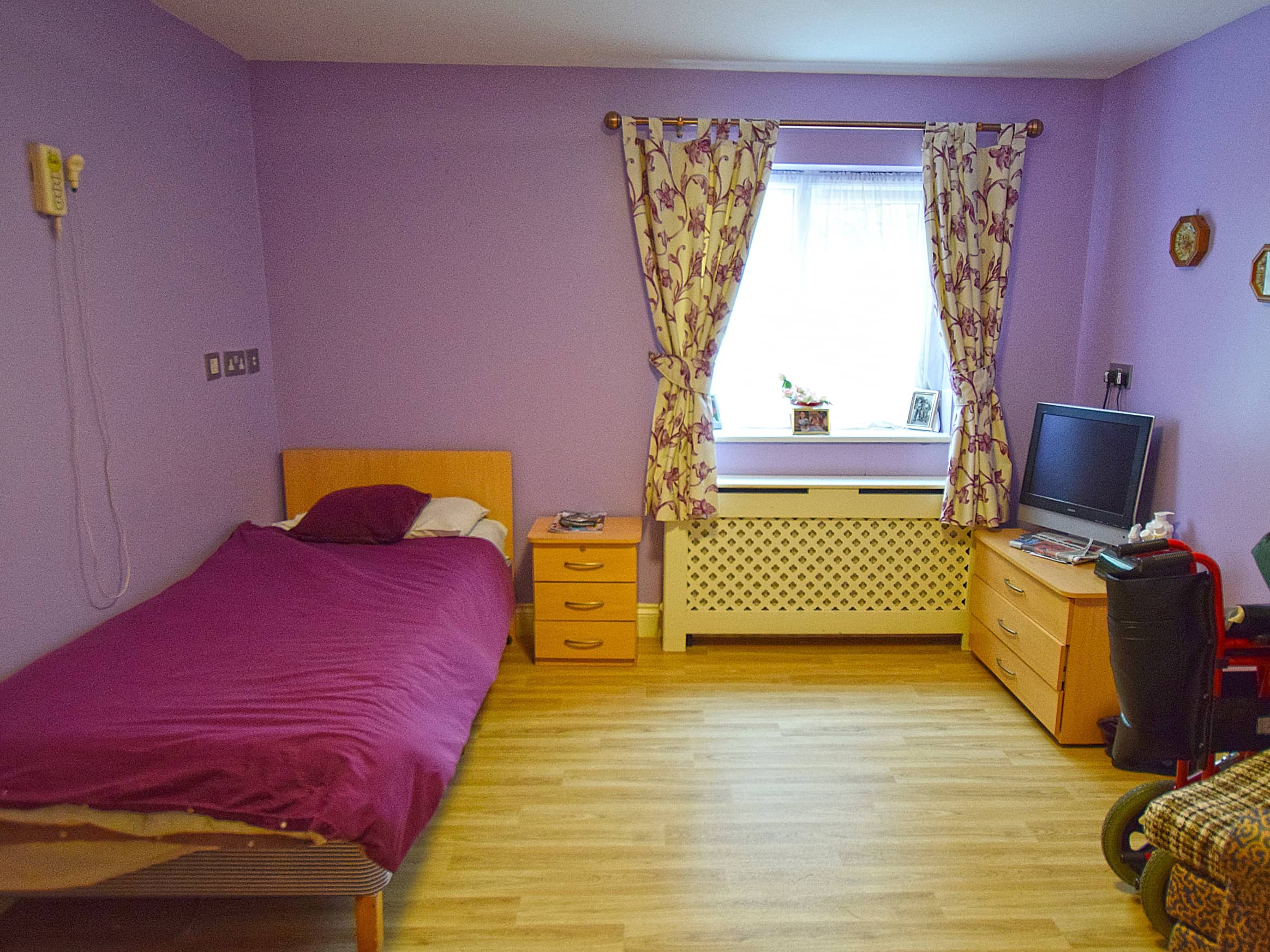 Private room with a bed, furniture, and window