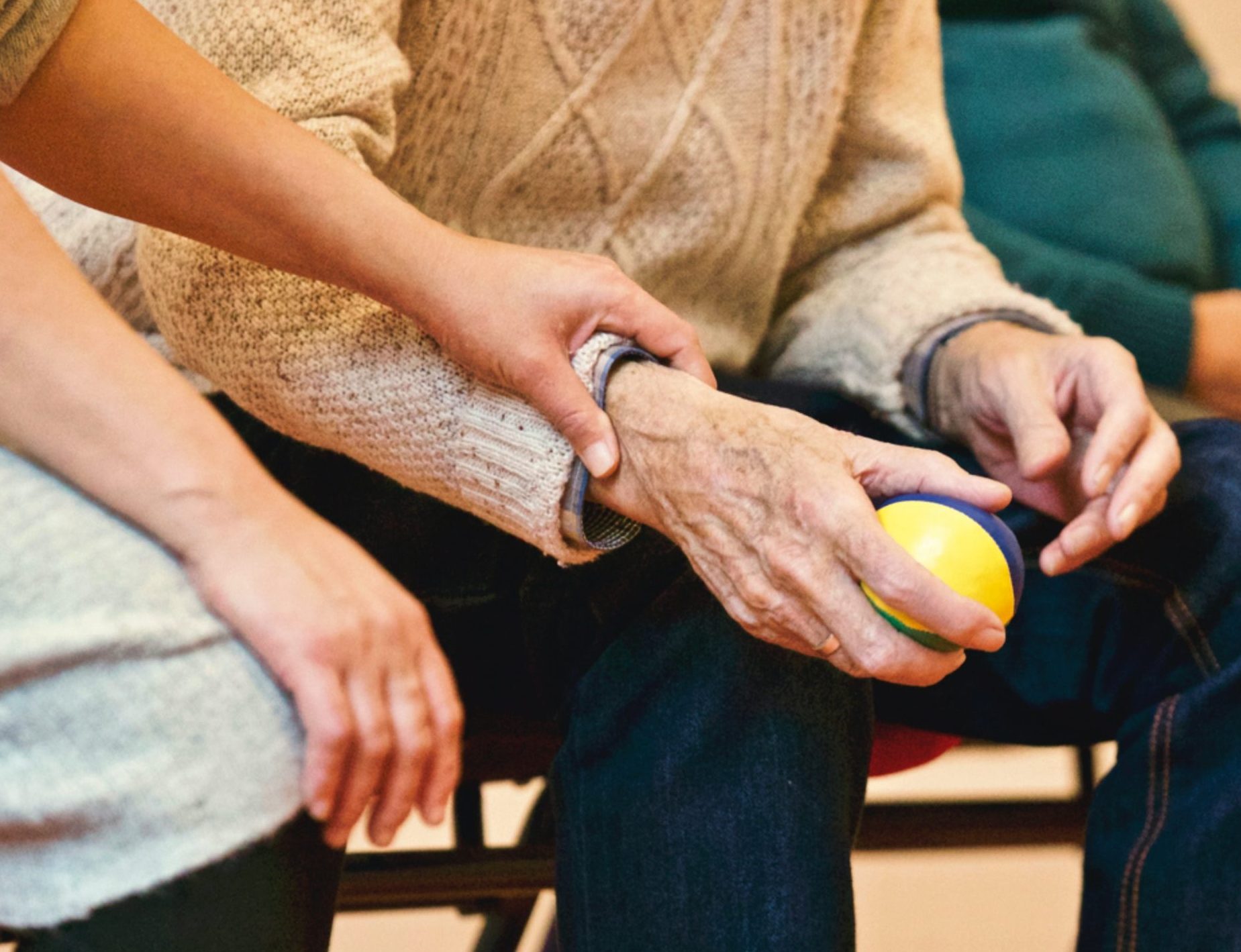 Resident engaging in an activity with staff assistance.