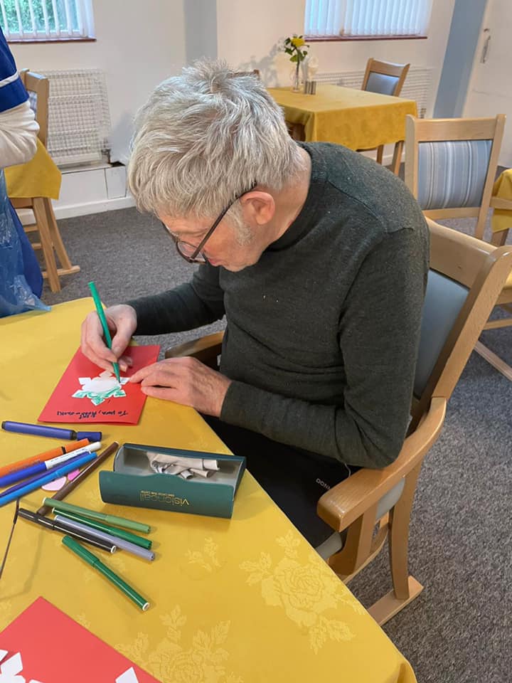 Resident engaged in an arts and crafts activity.