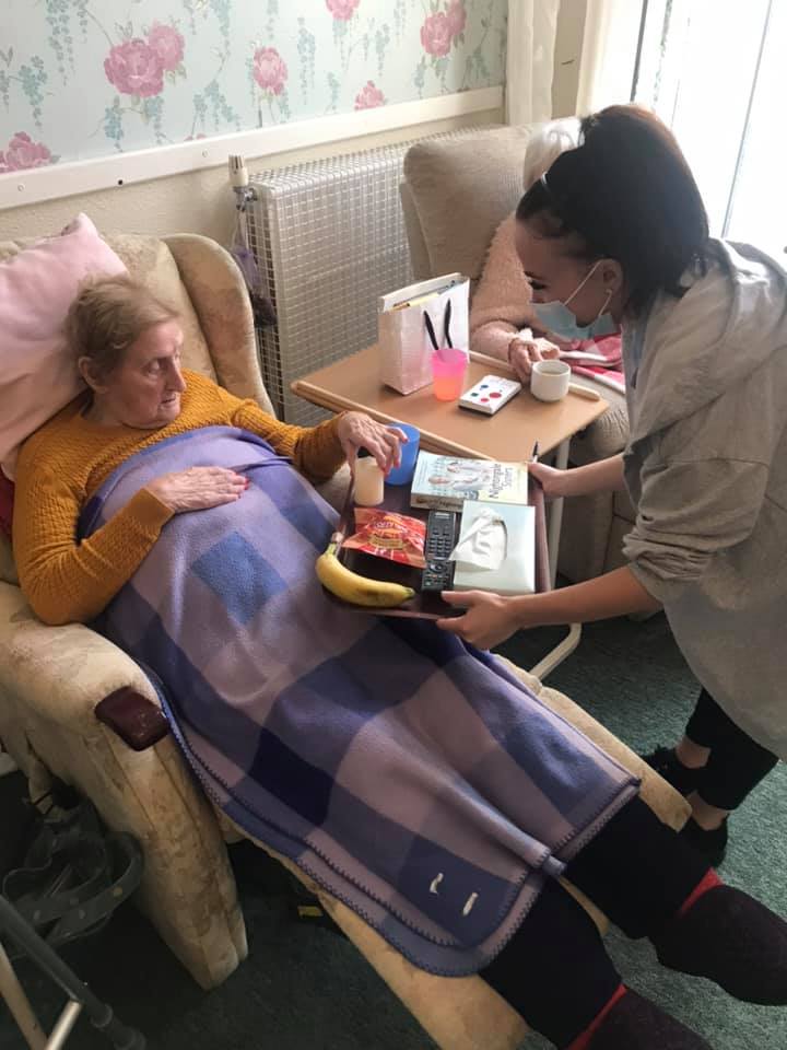 Care staff assisting a resident with food.