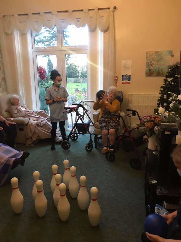 Residents participating in a bowling activity inside the facility.