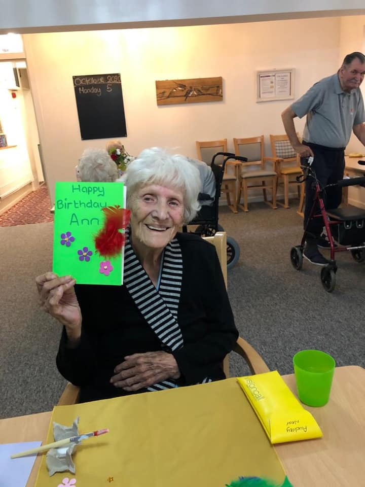 Resident celebrating with a birthday card
