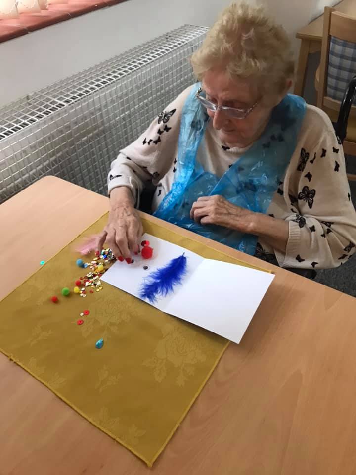 Senior resident engaging in a creative activity.