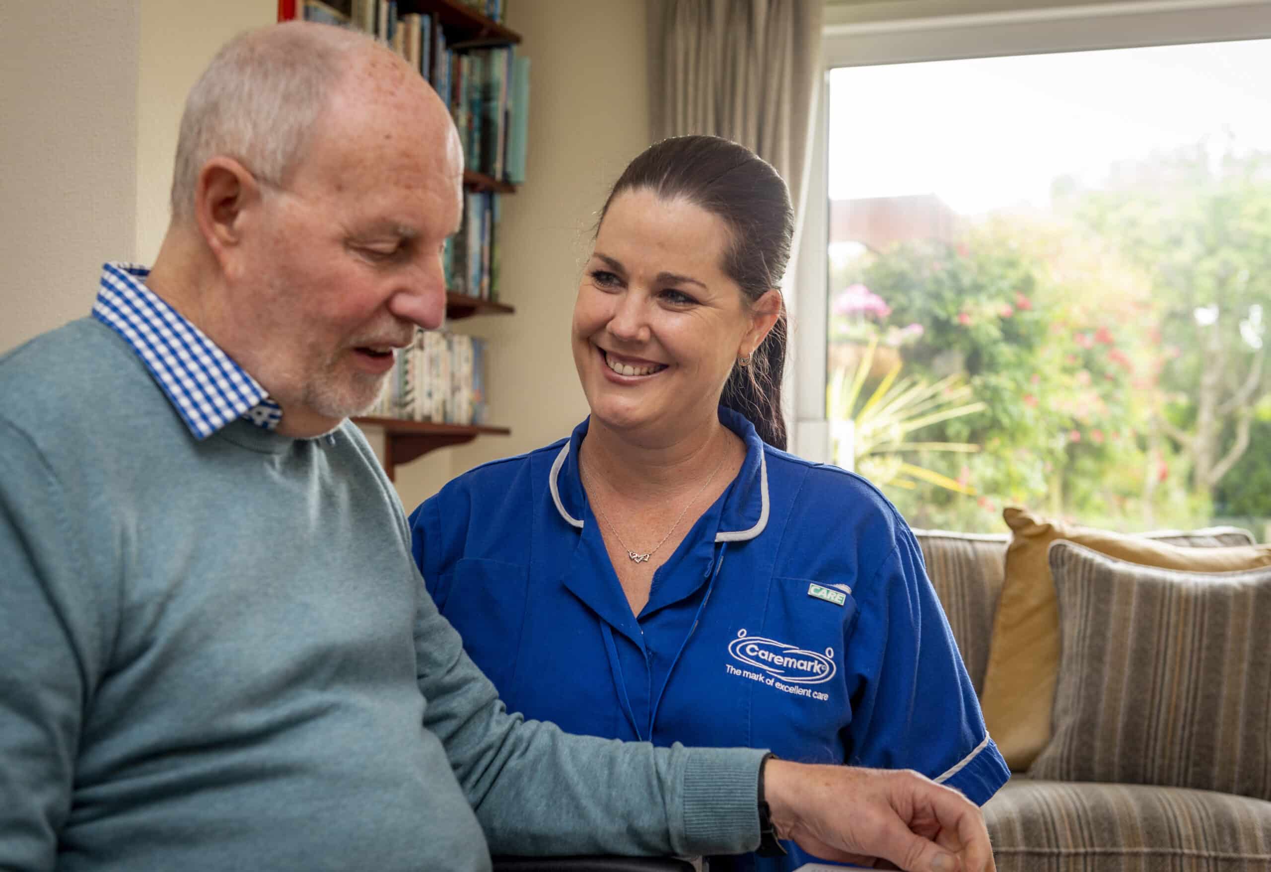 Staff member interacting with a resident in a cozy space.