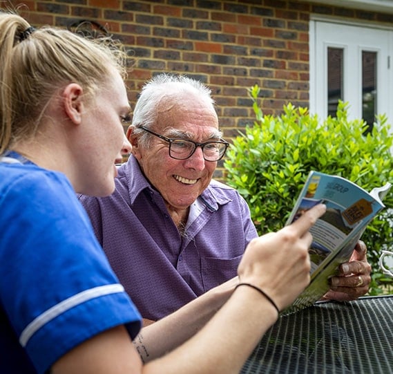 Care staff engaging with a resident outdoors.