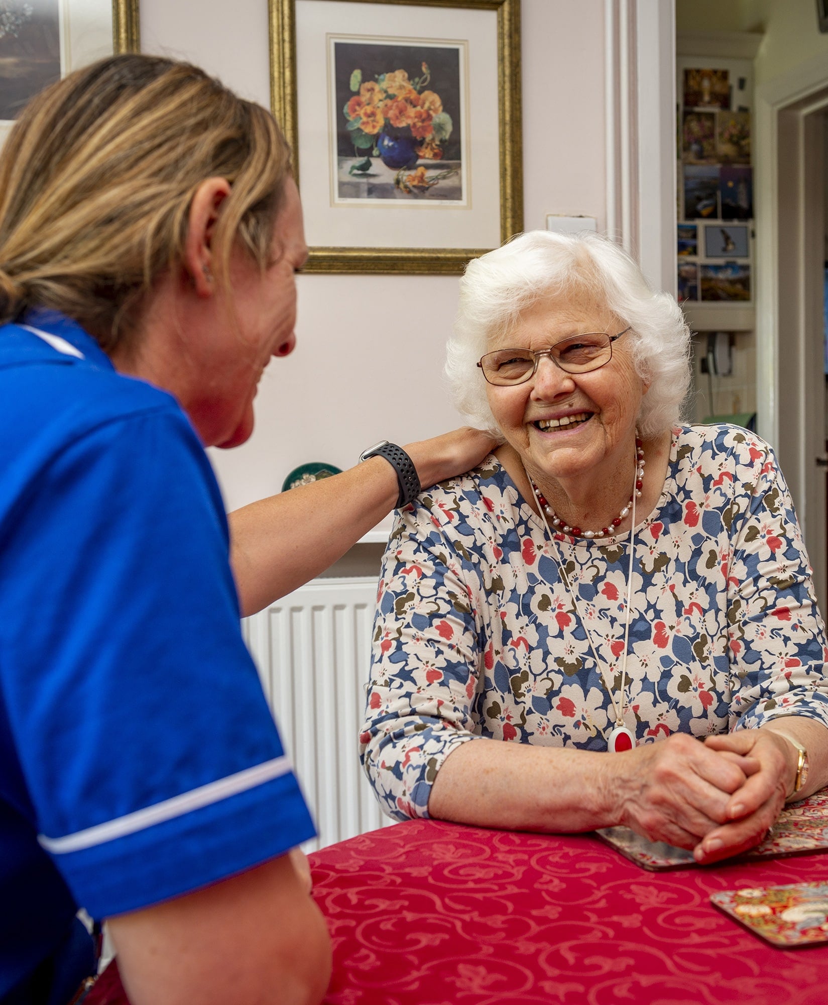 Staff member interacting with a smiling resident