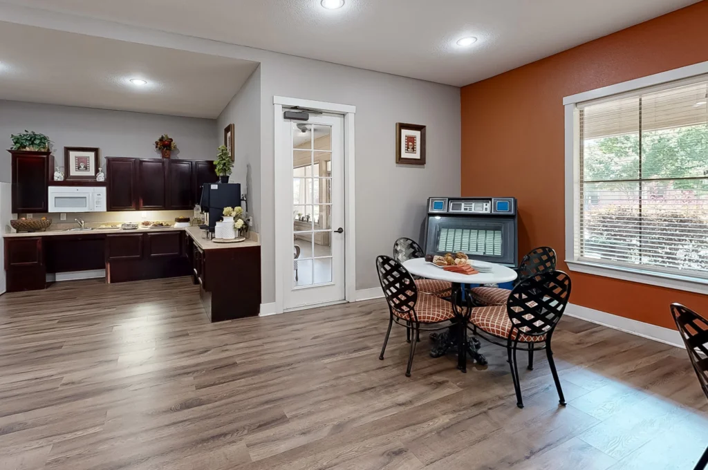 Interior dining area with tables and kitchen