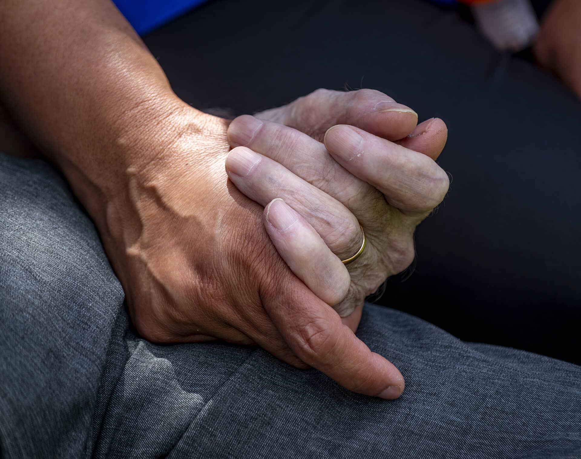 Two hands holding, symbolizing care and connection.