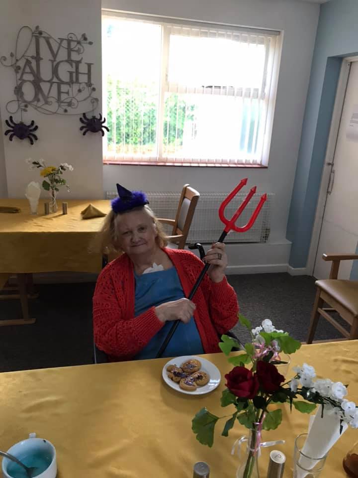 Resident enjoying a playful moment with snacks.