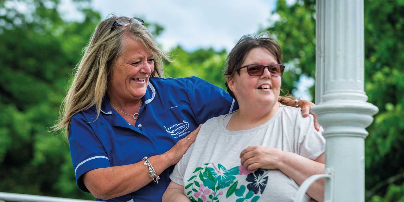 Staff member interacting with a resident outdoors