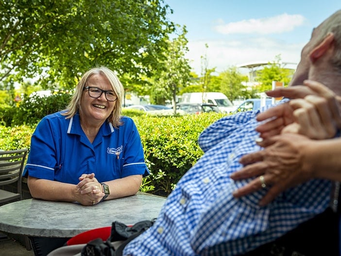 Staff member engaging with a resident outside