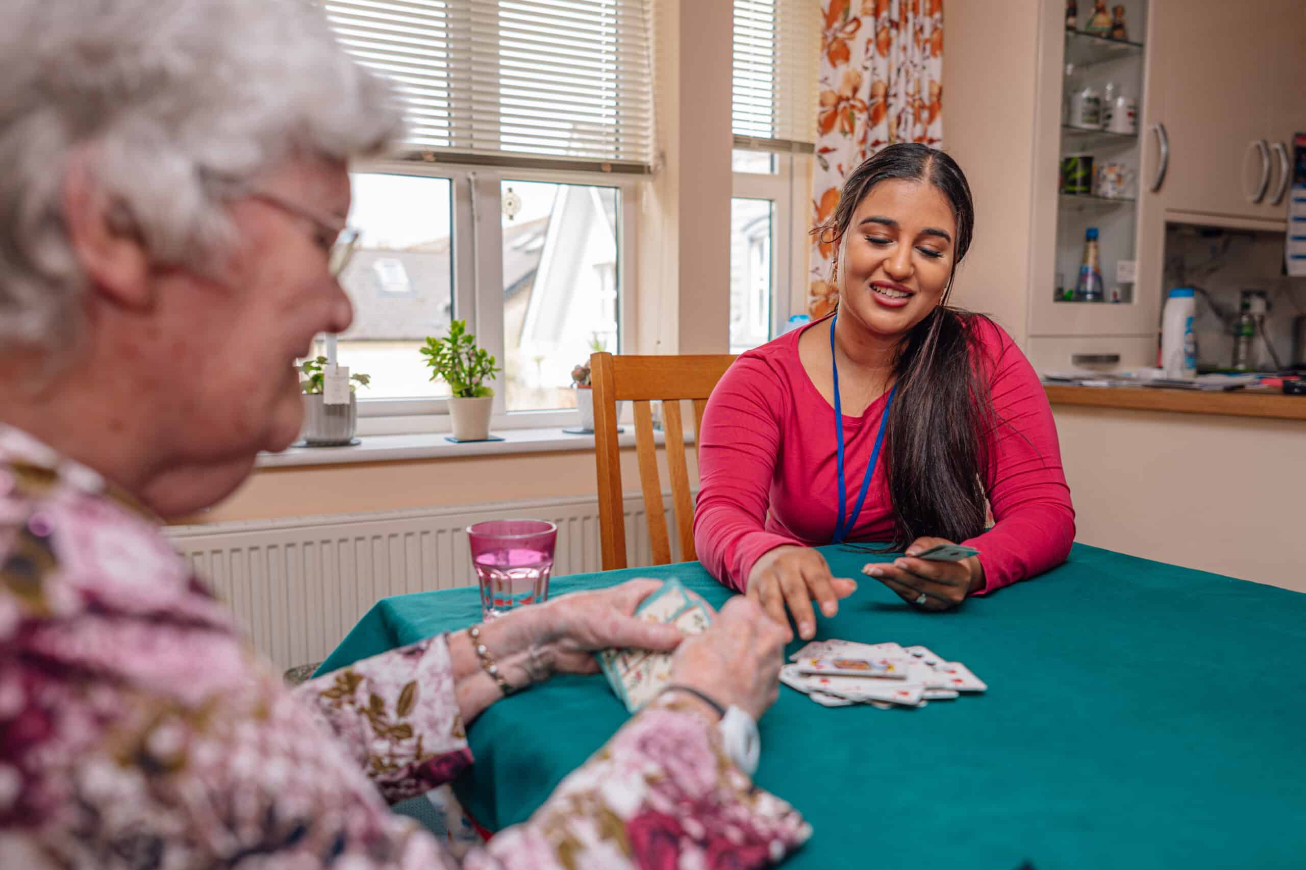 Staff member engaging with a resident at a table.