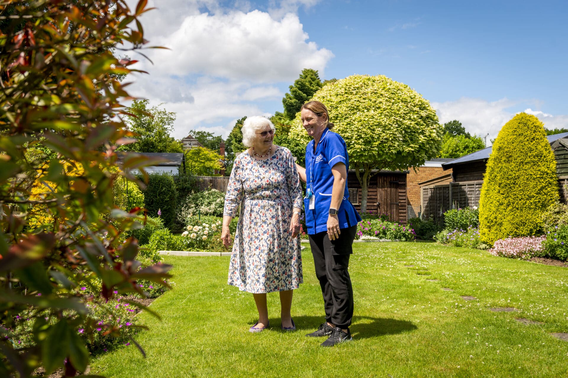Staff and resident enjoying the garden area