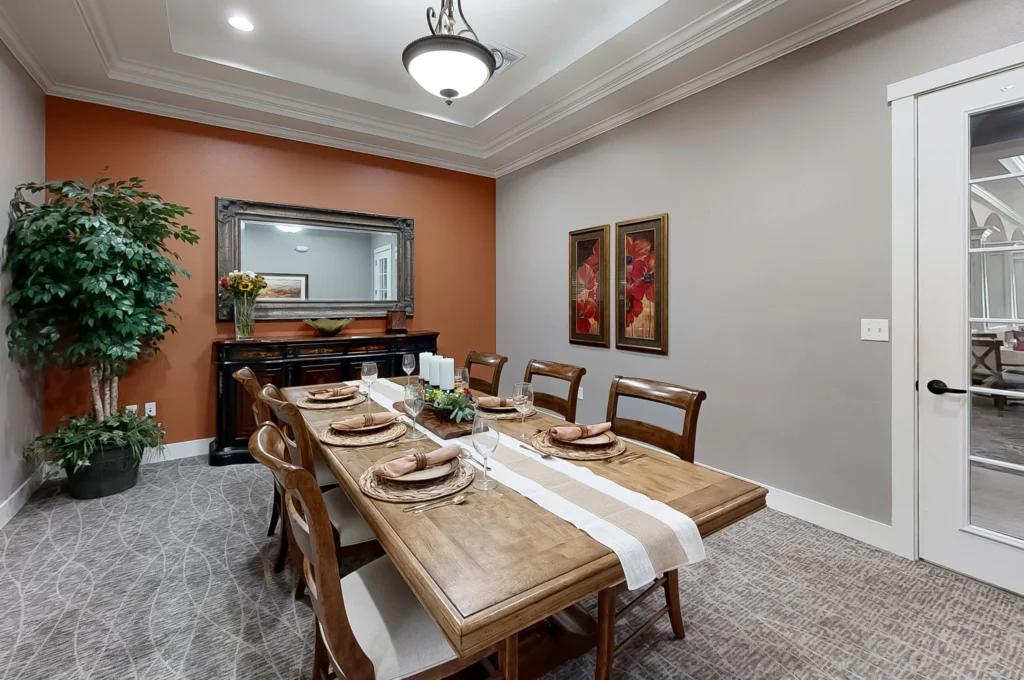 Elegant dining room with a wooden table and decorations.