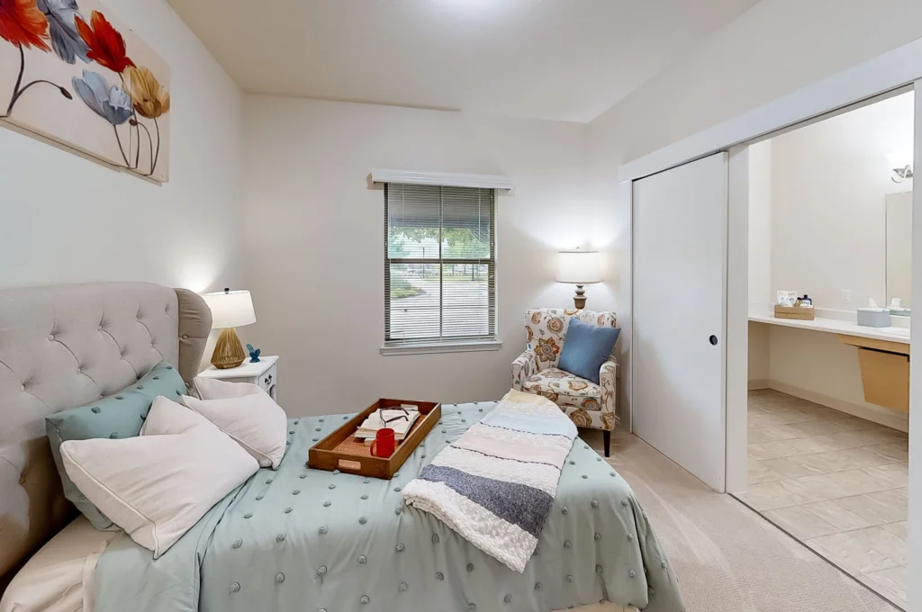 Cozy resident room with a bed and comfortable chair