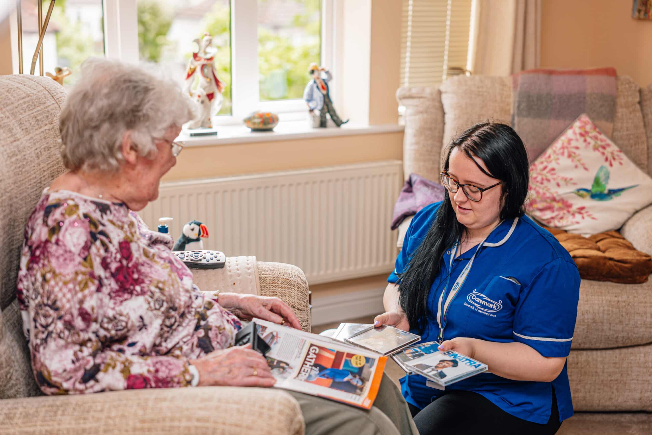 Caregiver engaging with a resident in a cozy setting.