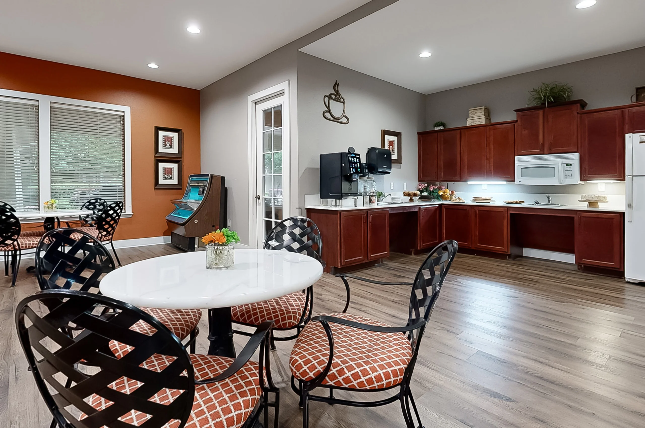 Common area with seating and kitchen facilities.