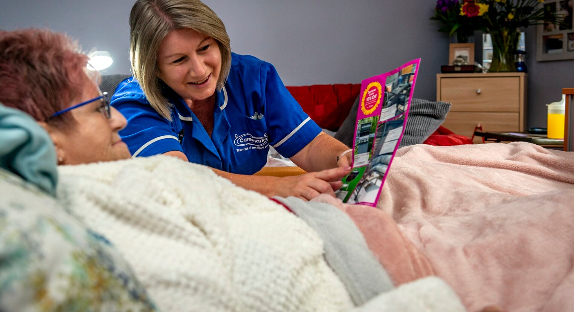 Care staff assisting a resident with information material