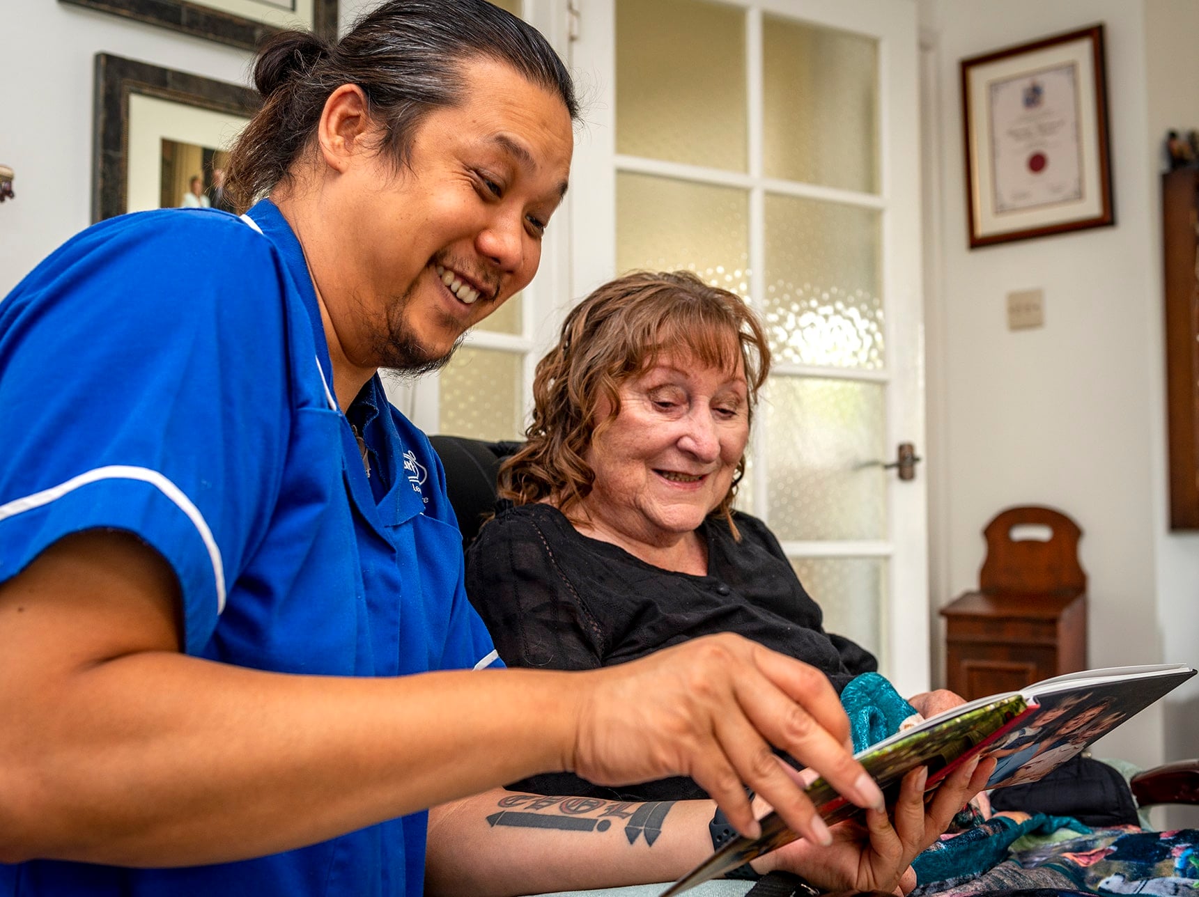 Care staff engaging with a resident happily