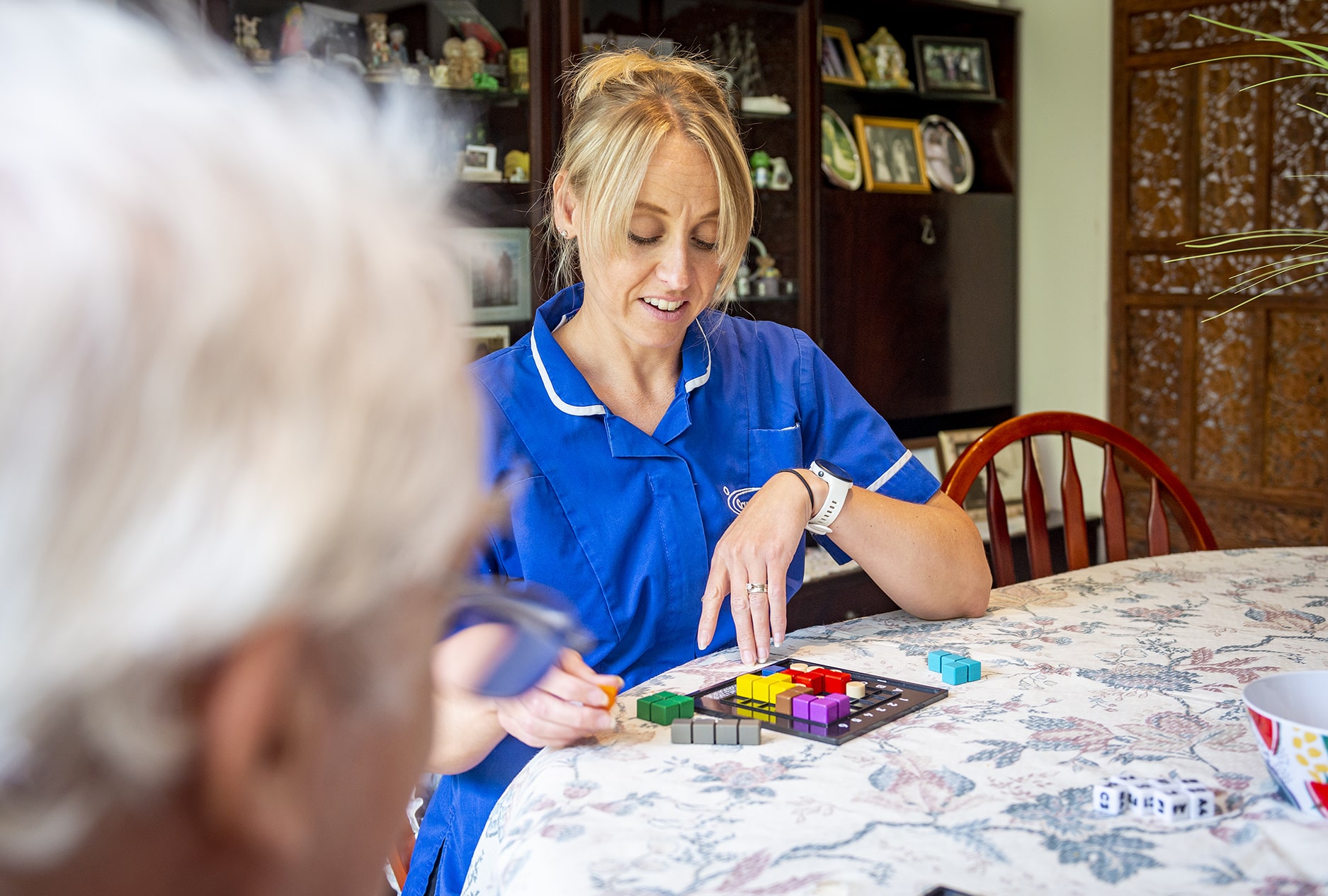 Care staff engaging with a resident in a game