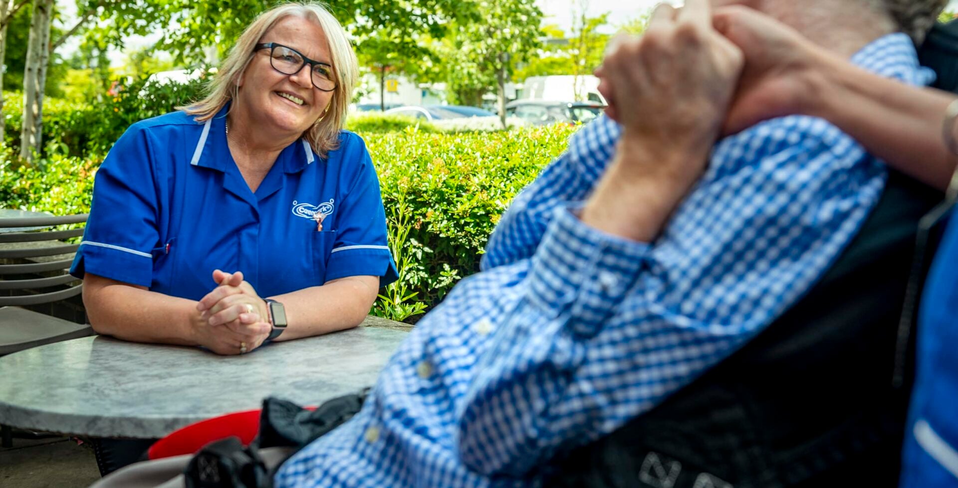 Staff member engaging with a resident outdoors.
