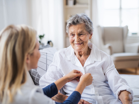 Caregiver assisting a senior woman at home