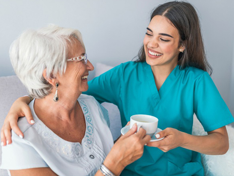 Caregiver and senior woman enjoying a warm moment together.