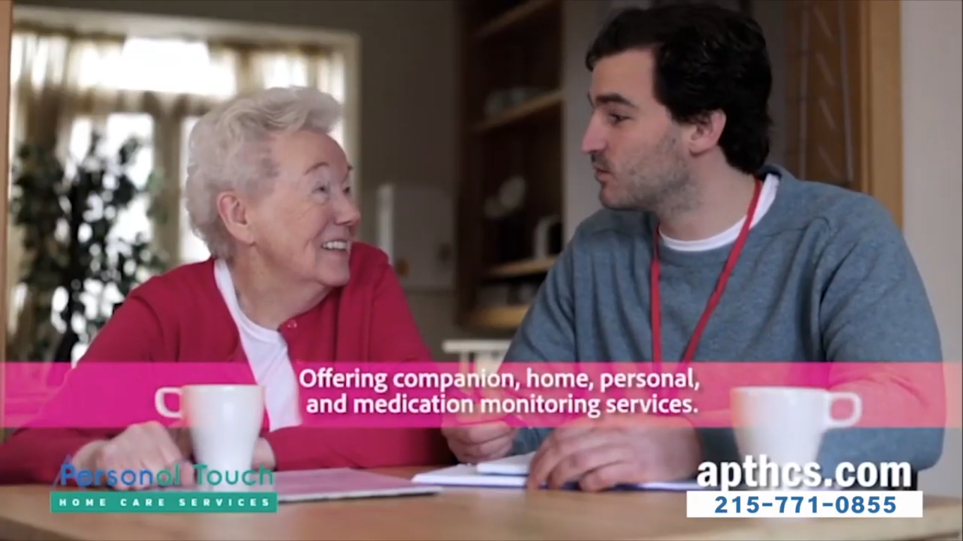 A caregiver and resident in a warm conversation.