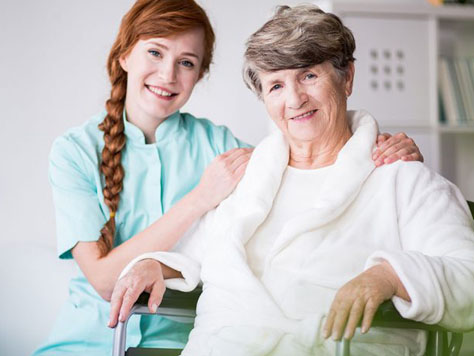 Caregiver with a smiling senior resident