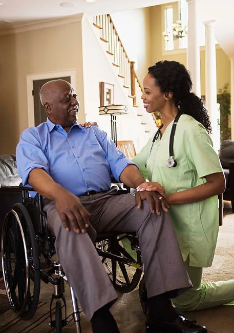 Caregiver interacting with a resident in a cozy indoor setting.