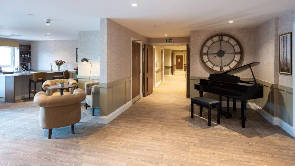 Spacious common area with seating and piano