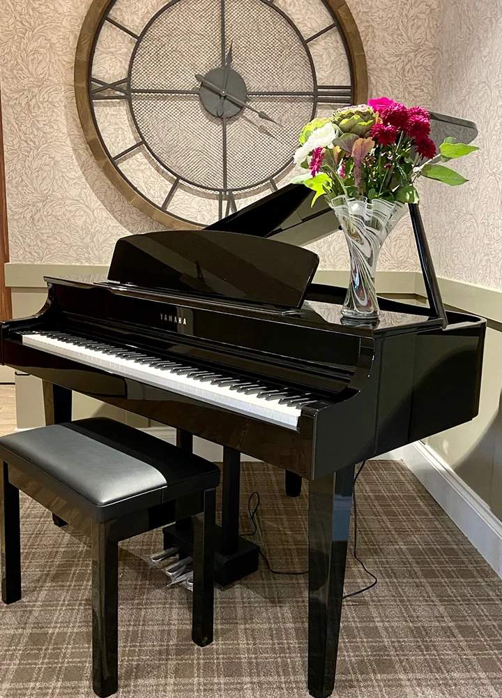 Piano with flowers in a facility setting.