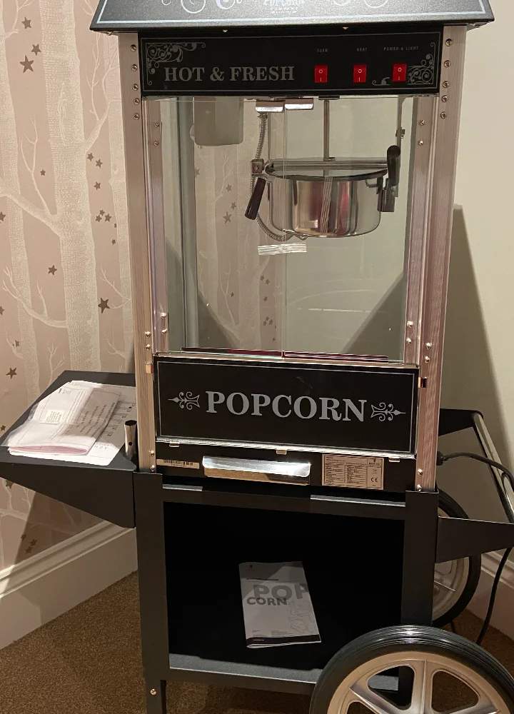 Popcorn machine in a cozy facility setting.