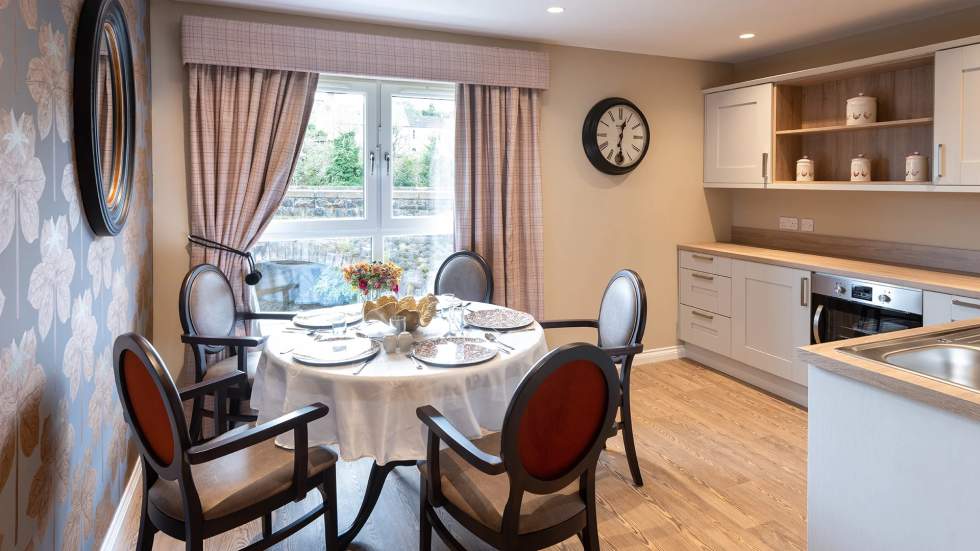 Cozy dining area with a round table and clock