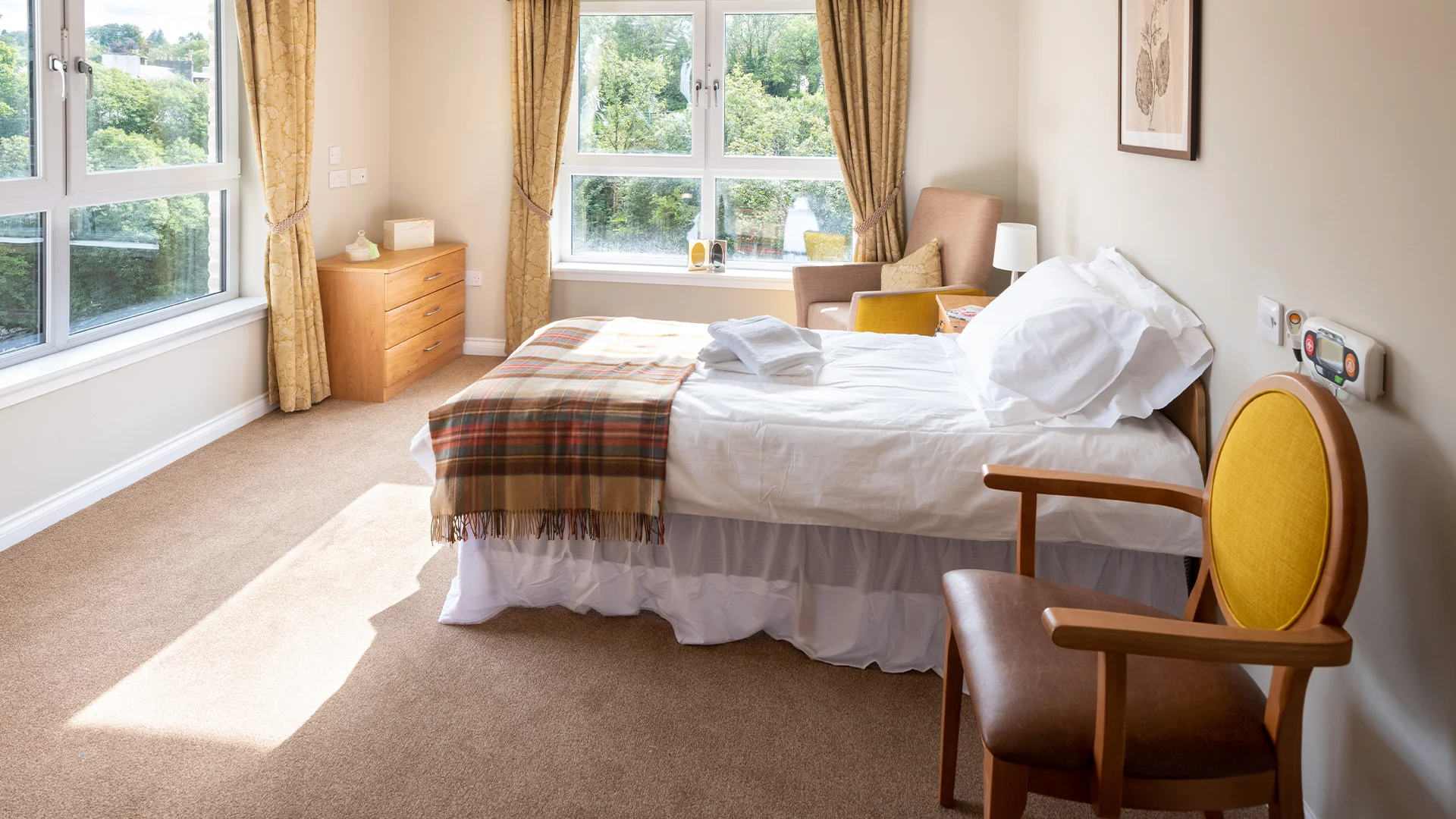 Cozy resident room with a bed and armchair