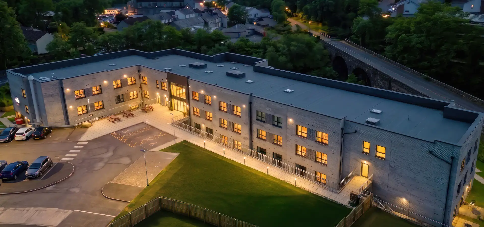 Aerial view of Escan Manor building at dusk