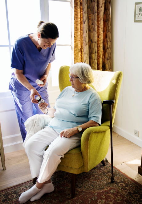 Nurse assisting a senior in a cozy chair