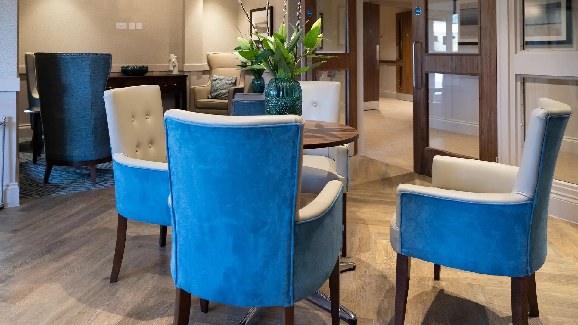 Cozy common area with blue chairs and flowers