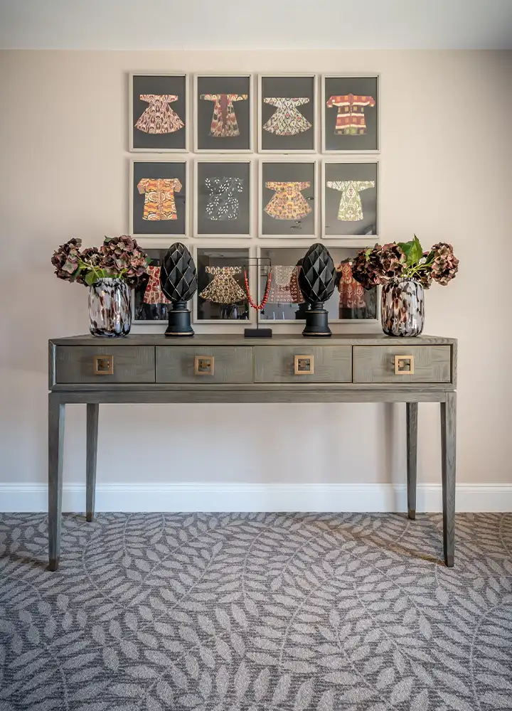 Decorative console table with framed art pieces