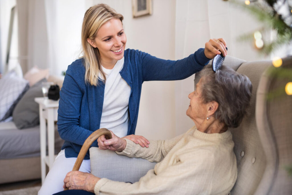 Caregiver assisting an elderly resident with grooming.