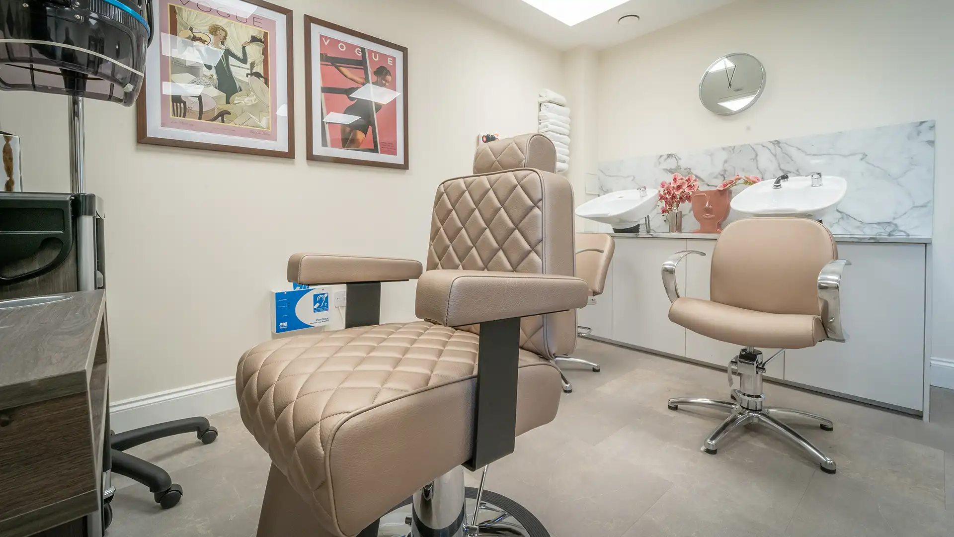 Hair salon area with stylish chairs and decor.