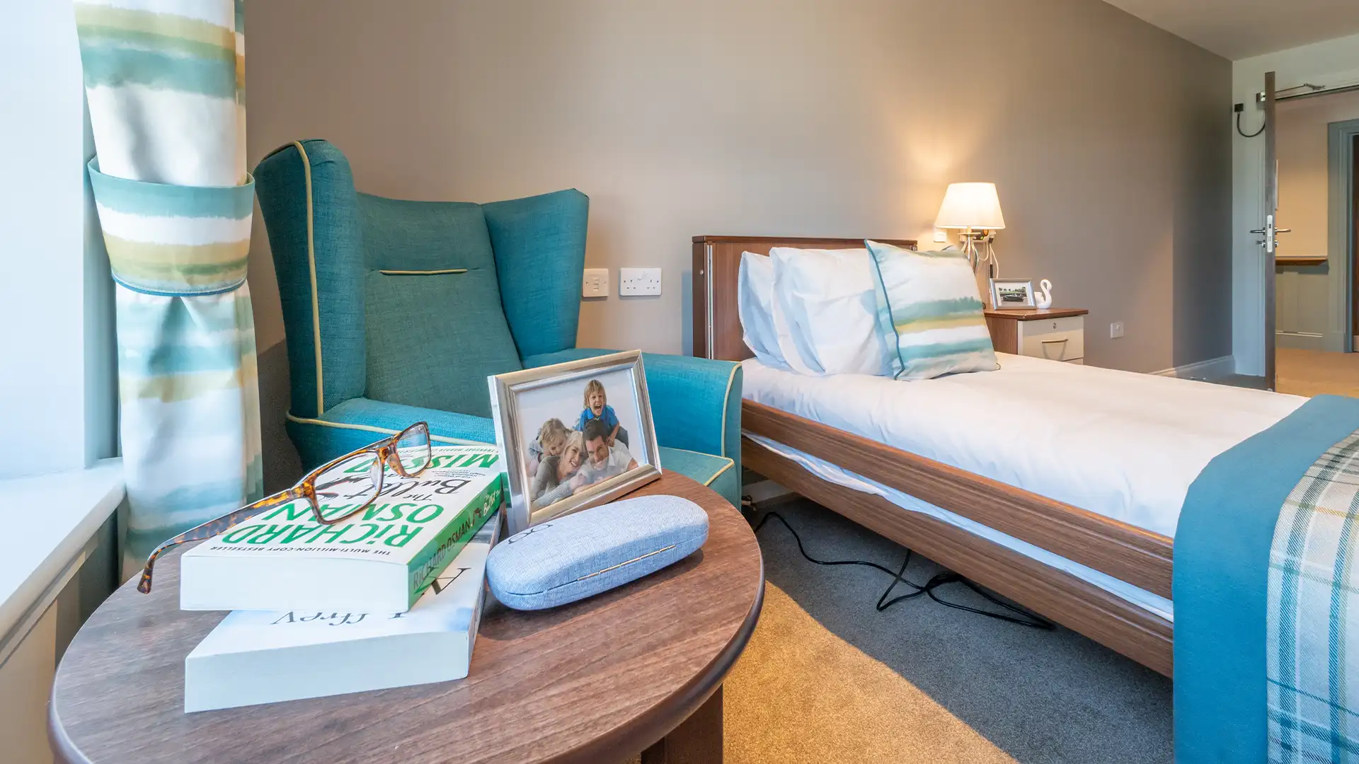 Cozy nursing home bedroom with personal touches.