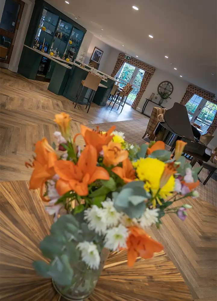 Interior of a common area with flowers in focus.