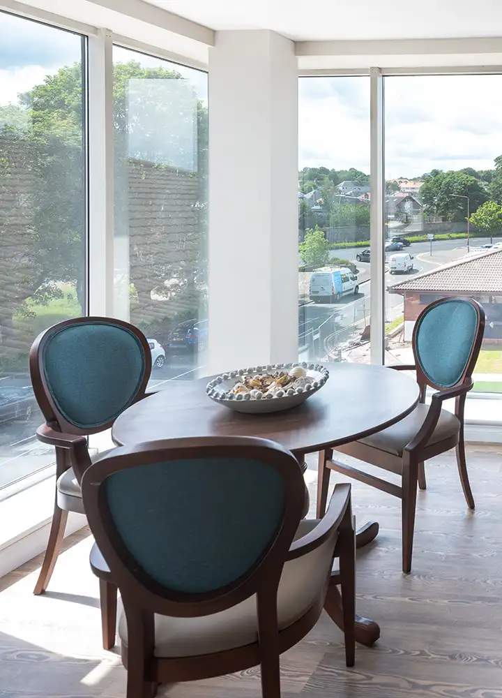 Bright common area with stylish chairs and a table.