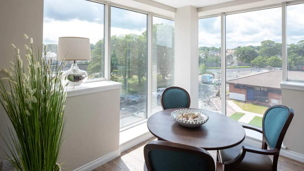 Bright common area with a view and seating.