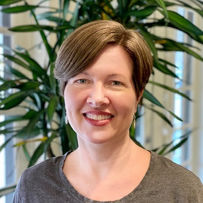 Smiling staff member in a facility setting.