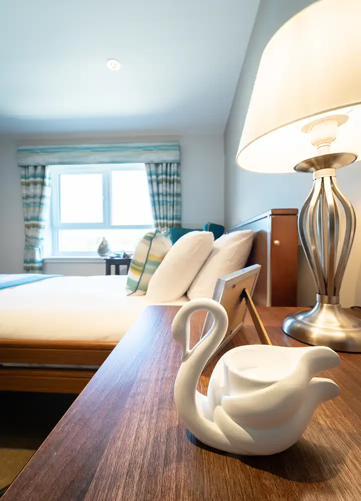 Cozy bedroom with a decorative bedside swan