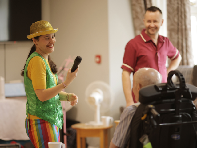 Entertainer performing for residents in a common area