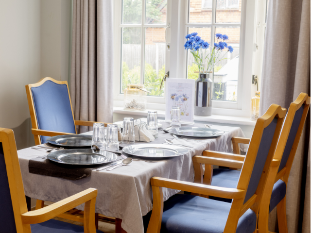 Dining table set with plates and flowers