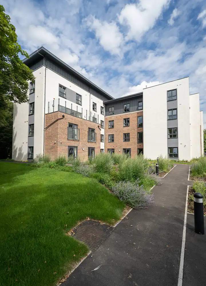 Exterior view of Escan Manor building with greenery